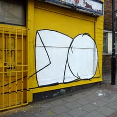 Sleeper mural on a yellow shutter on Mare Street, Hackney
